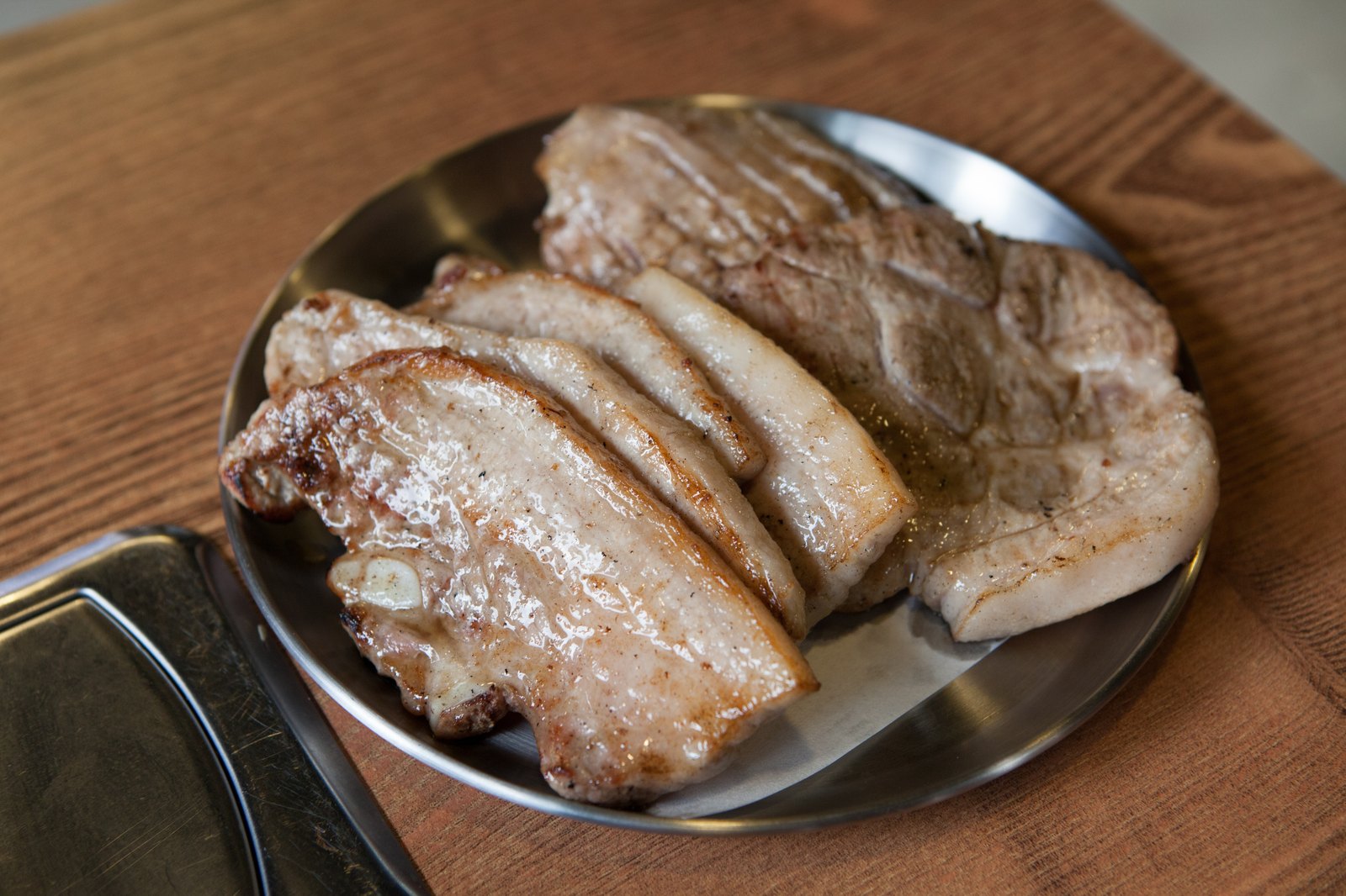 Samgyeopsal pork belly grilling on a Korean BBQ grill